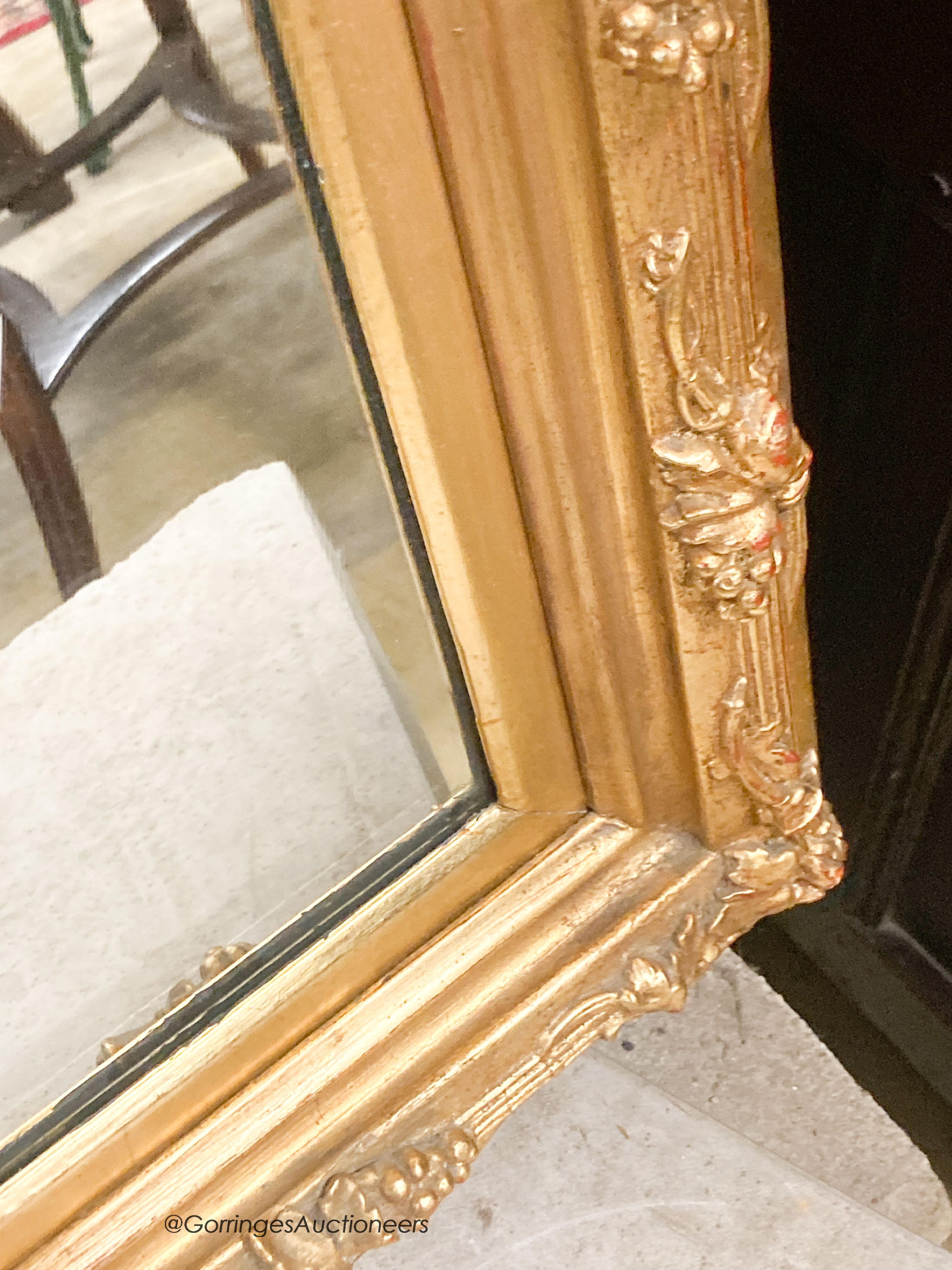 A rectangular carved giltwood framed wall mirror, width 67cm, height 132cm